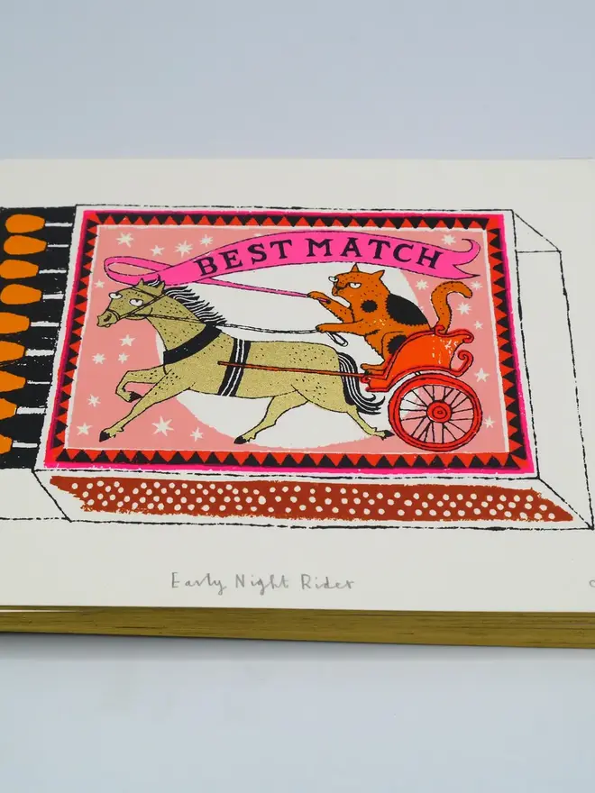 Cat And Horse Matchbox Screenprint Early Night Rider, a white screenprint with a match box design in the centre on top of a baby blue backdrop. 