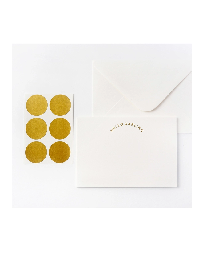 Notecard set with warm white notecard that says 'Hello Darling' in gold embossed foil with matching envelope and set of metallic gold seals sticker labels.