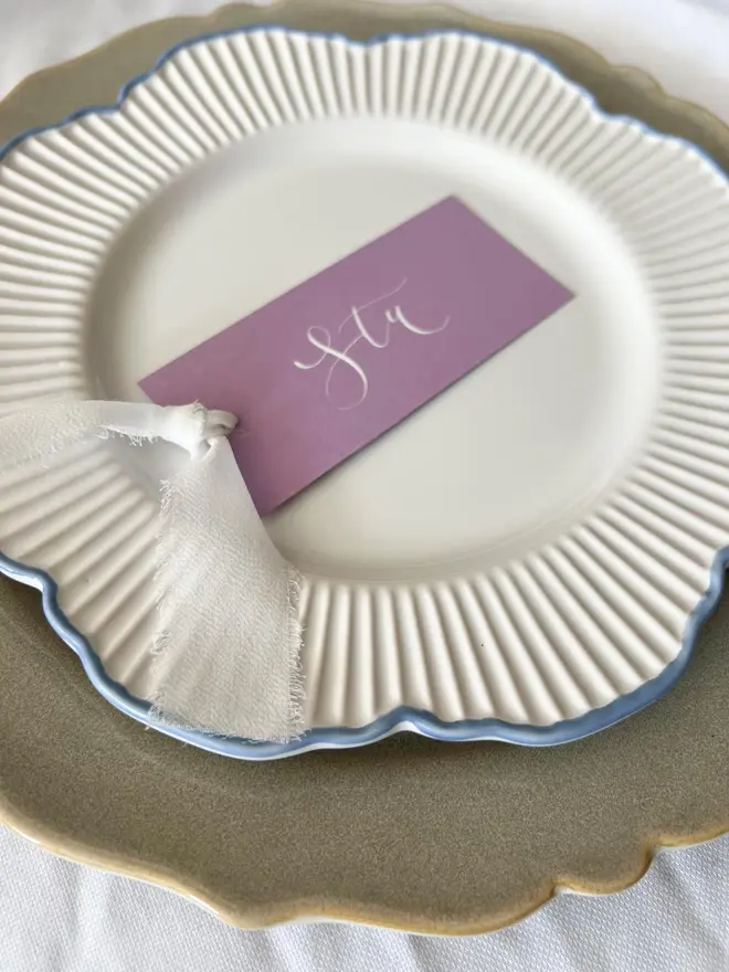 Personalised Calligraphy Wedding Lilac Place Cards, lilac place card written on a white plate. 