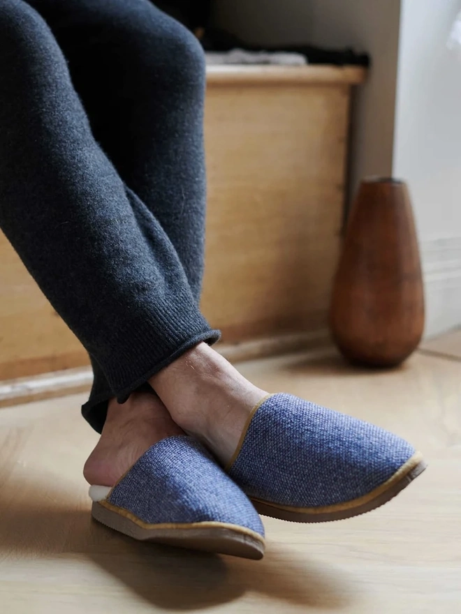 Women's Lambswool & Sheepskin Slippers, a person wearing a pair of colourful slippers indoors. 