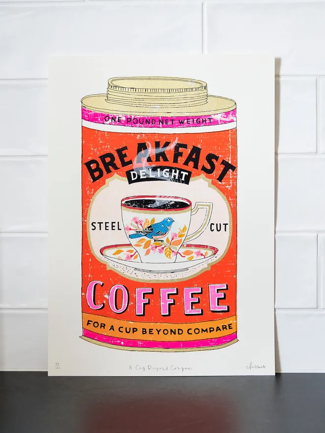 Screenprint A Cup Beyond Compare, a colourful coffee tin design in the centre of a white screenprint. 