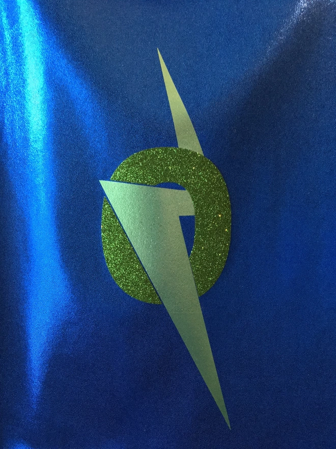 Blue fabric with green lightning bolt and green glitter 'O' initial