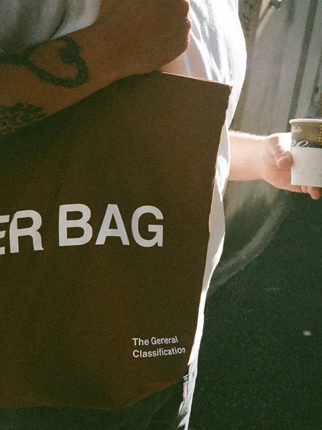 'Beer Bag' Tote Bag, worn by a man with tattoos.