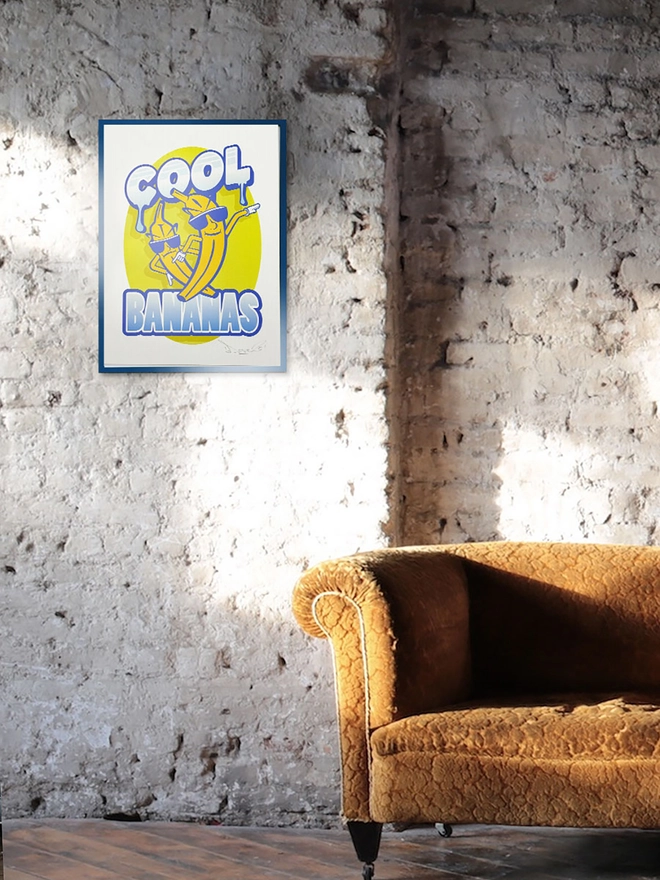 'Cool Bananas' Signed embossed fine art print, against a brick background. 