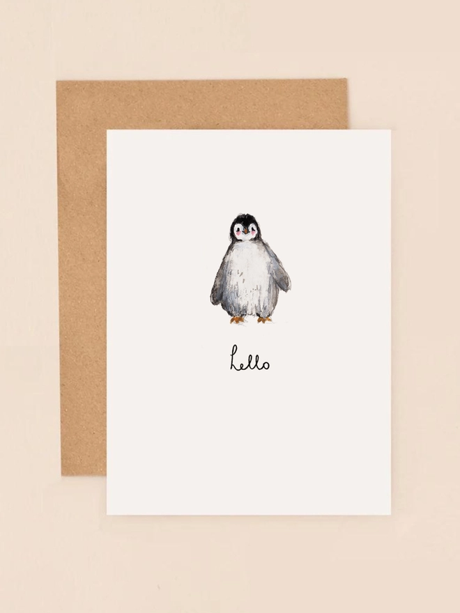 A cute illustration of a small penguin standing upright with a cheerful expression, holding a tiny sign that reads "Hello." The penguin's black and white feathers and orange beak are depicted in soft, charming detail. The design has a light, minimalist style with a pastel background, perfect for sending a sweet and simple greeting