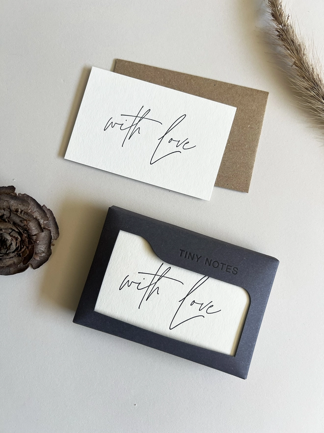 Tiny notes box with a card and envelope next to it.