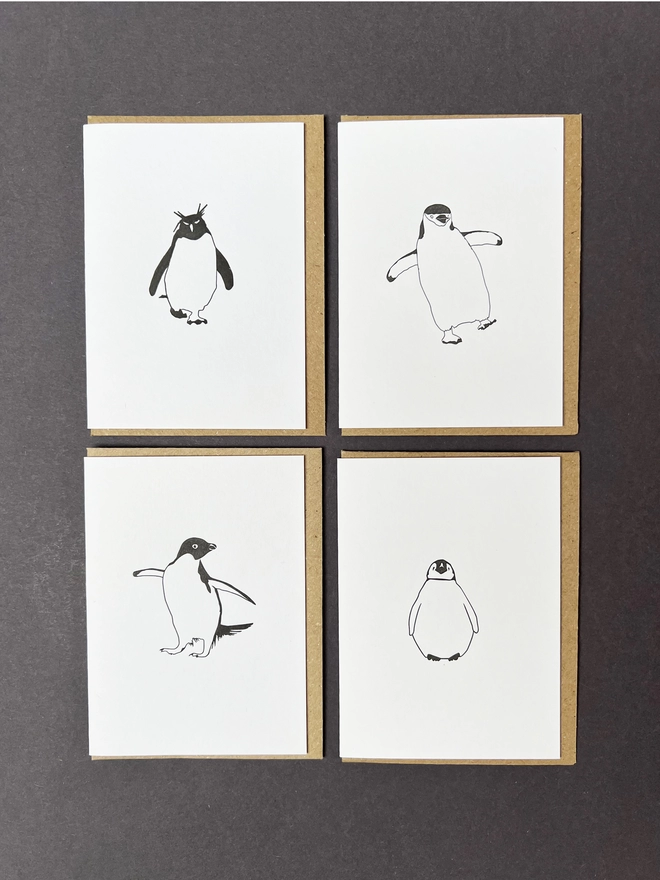 Four letterpress printed penguin designs showing the Rockhopper, Chinstrap, Adelie and baby emperor penguins