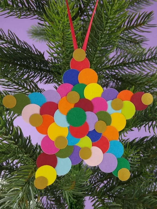 Small Rainbow Star Christmas Ornament hanging on a Christmas tree
