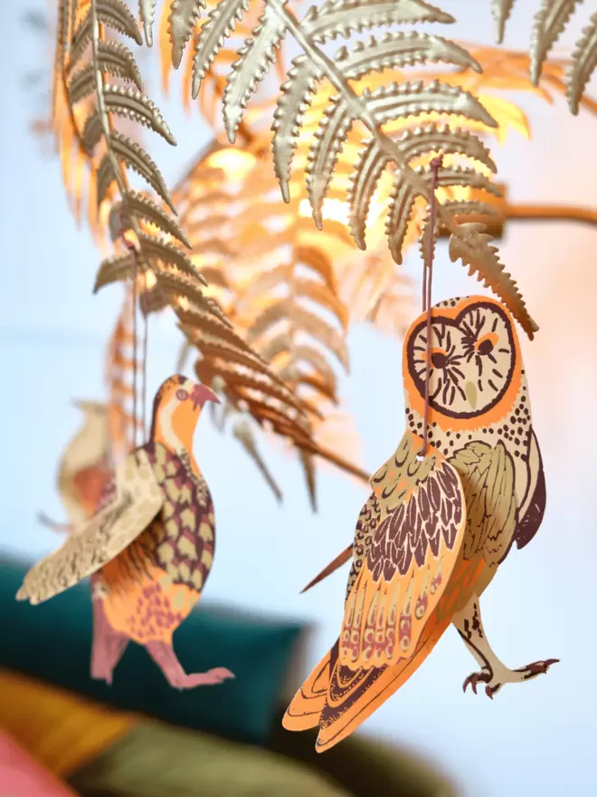 Owl winter bird hanging from gold lamp