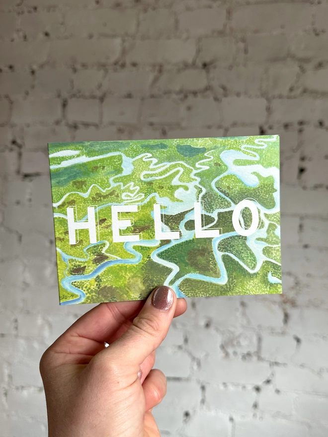 a greetings card featuring an illustration of some of the Everglades landscape with the text “hello”