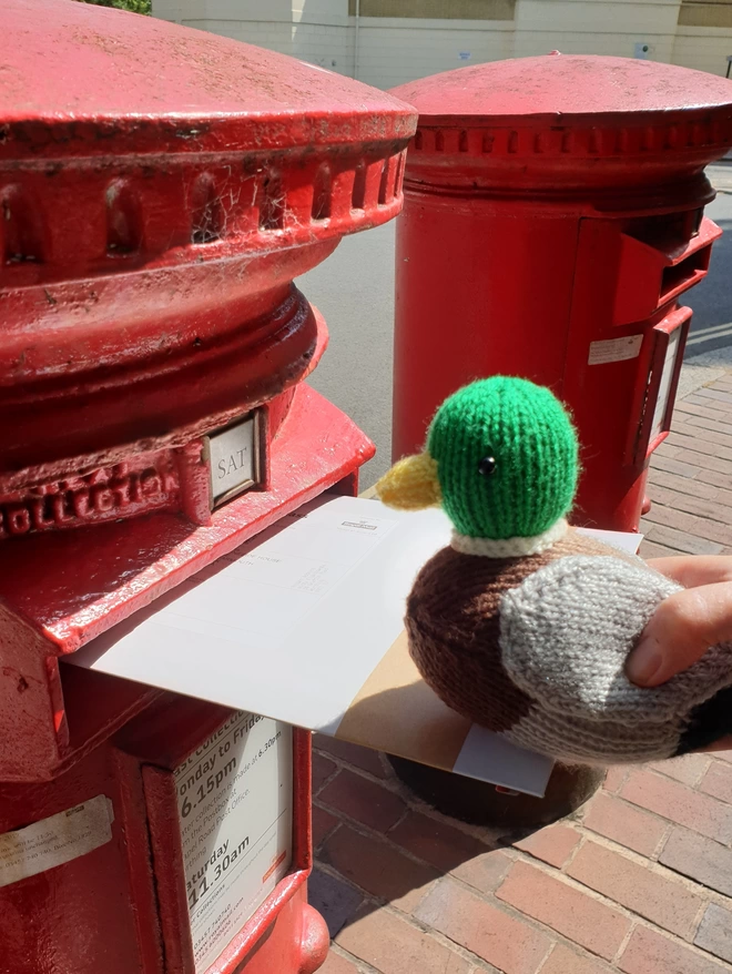 Knitted duck posting a parcel 