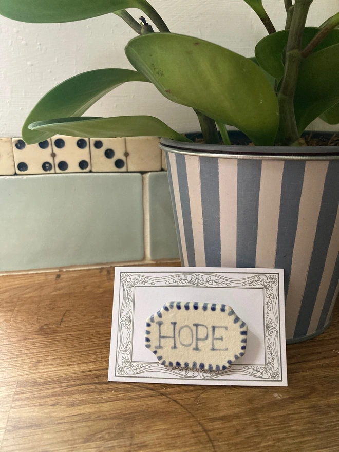 porcelain hope badge on card