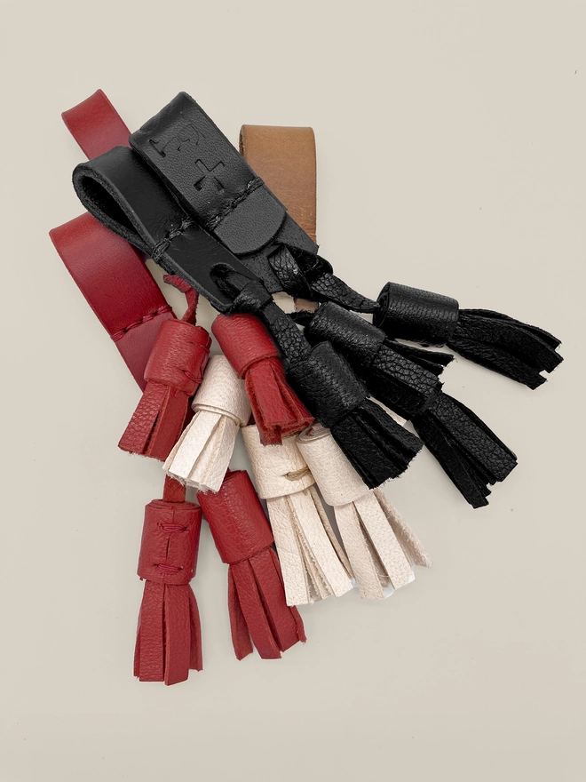 bunch of leather tassels displayed in 3 colours