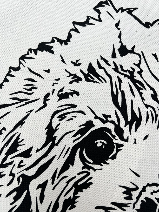 Close up of the cockapoo face printed on the tea towel