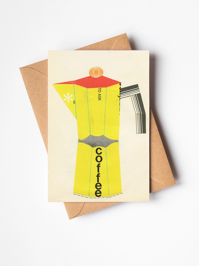 A greetings card and brown kraft envelope depicting a bright red and yellow coffee pot.