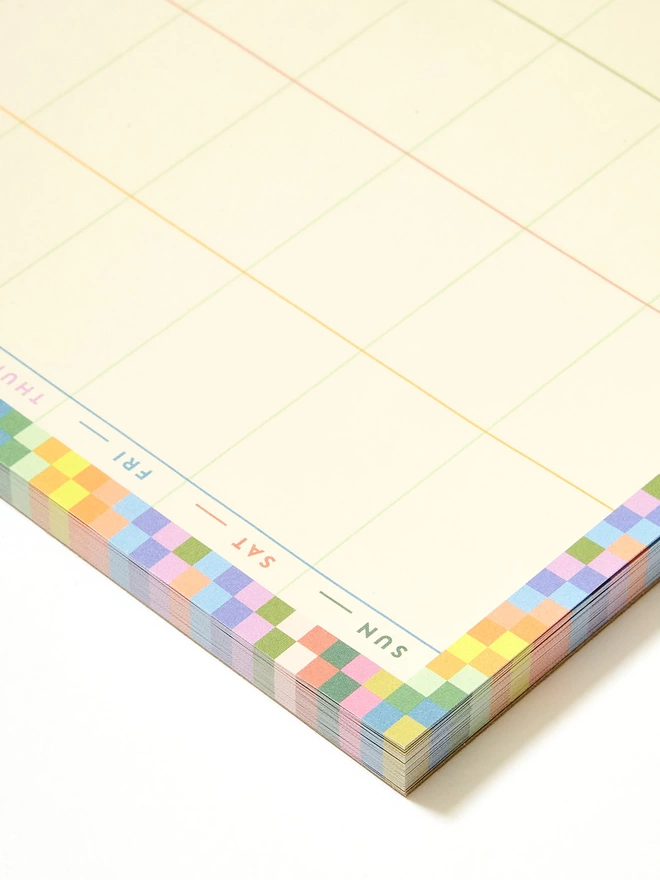 The Family weekly planner has a multicoloured rainbow check boarder, with each day written in a different colour