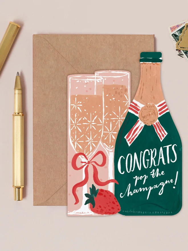 Pop The Champagne Congratulations Card by Sister Paper Co with a kraft envelope