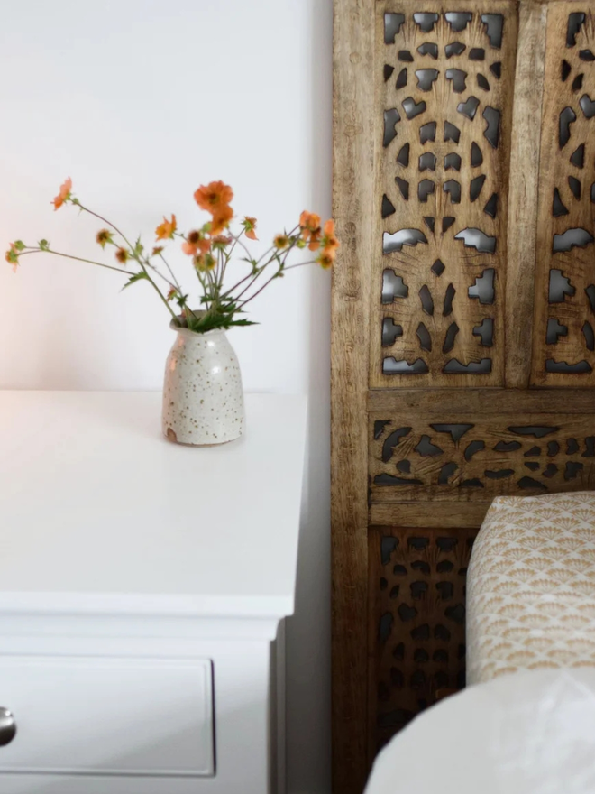 Wavy stoneware bud vase. A small stoneware bud vase with a wavy rim