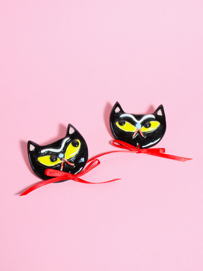 Spooky grumpy Black Cat Brooch with yellow eyes and red satin ribbon.