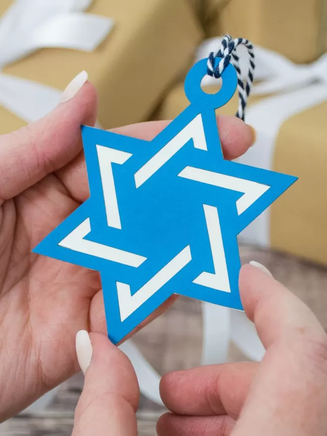 Star of David Hanukkah Gift Tag held in models hand