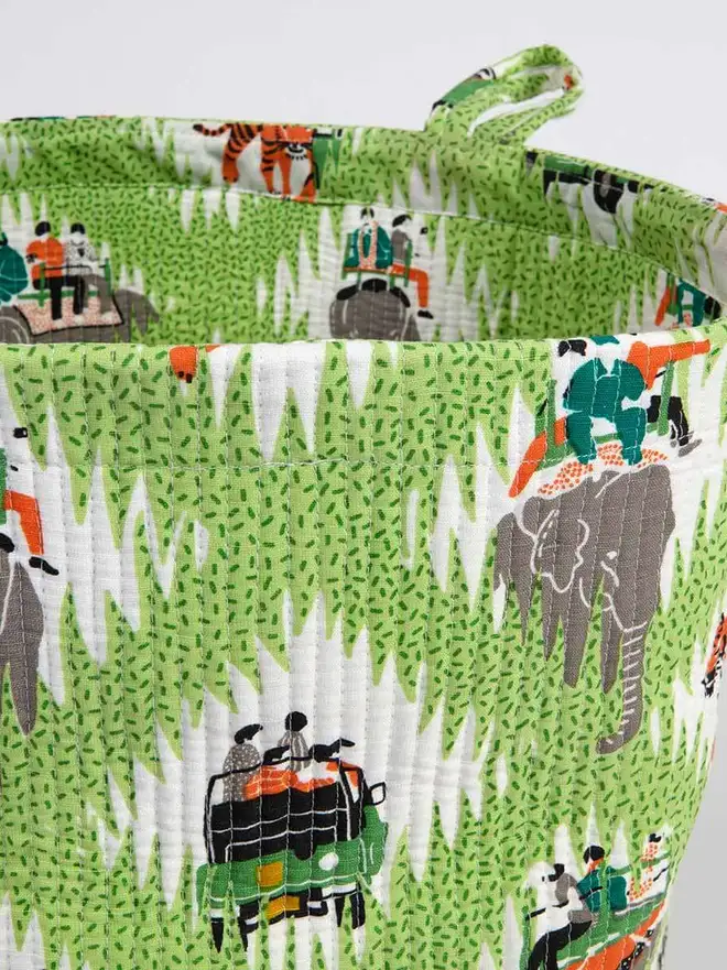 Tiger Safari Quilted Storage Basket, a green safari basket sitting against a grey backdrop. 