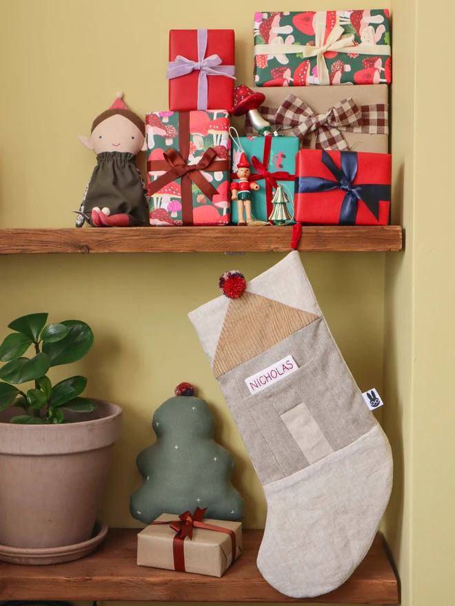 Personalised Linen Christmas Stocking with Christmas presents and elf dolls