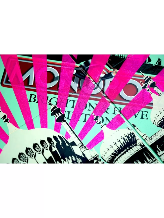 Cropped close up of Monopoly board with Brighton Pavilion printed on top with pink stripes