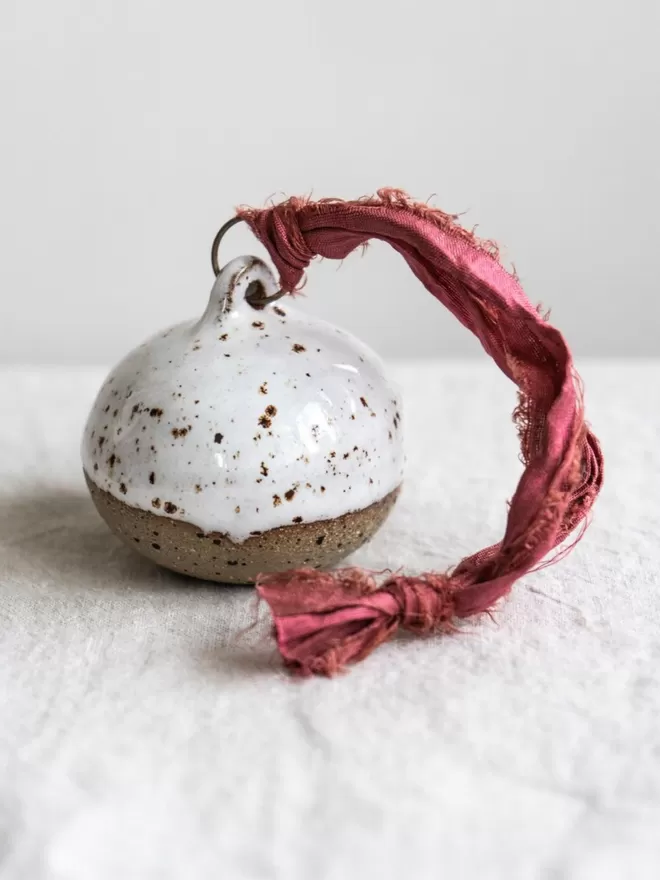 Half Dipped Flecked Christmas Bauble seen on a simple linen table cloth
