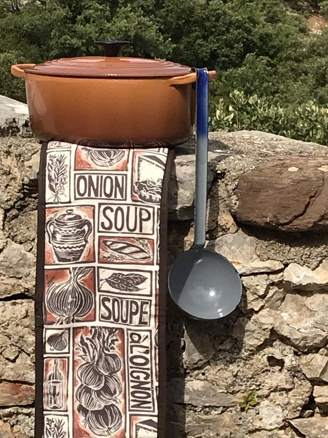 French Onion Soup oven glove on a wall with a pot
