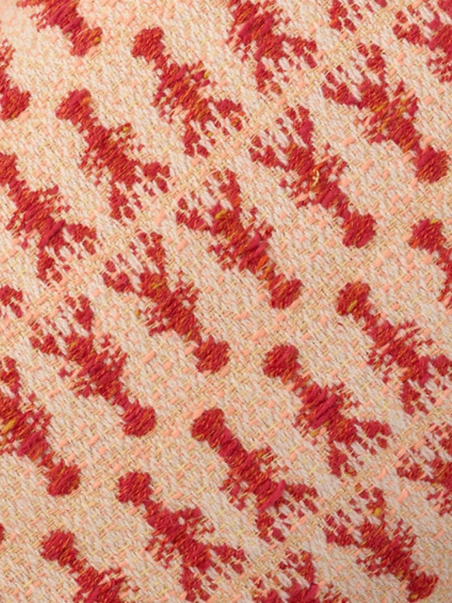 lobster tassled rectangular cushion. a close up of a rectangular cushion embroidered with red lobsters.