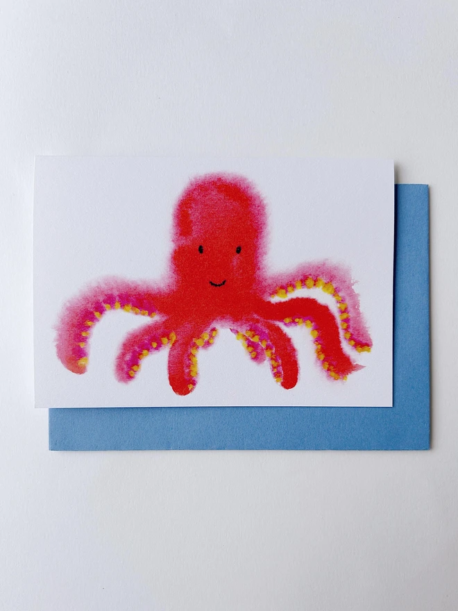 A greetings card featuring an illustrated bright pink octopus in a child like drawing style.