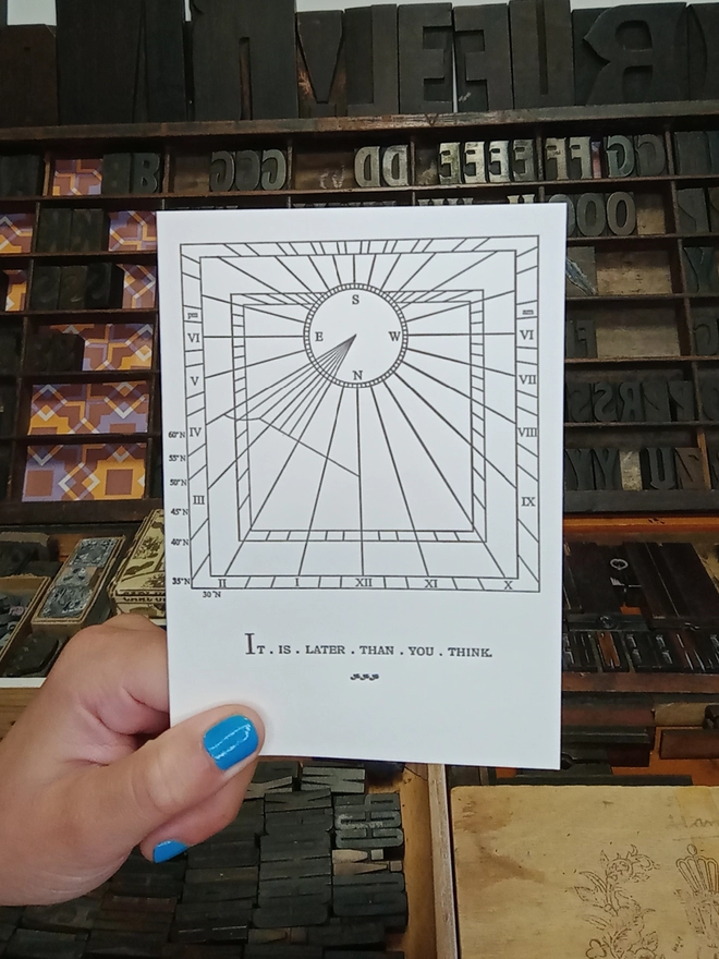 A Letterpress Sundial card seen held up in the studio