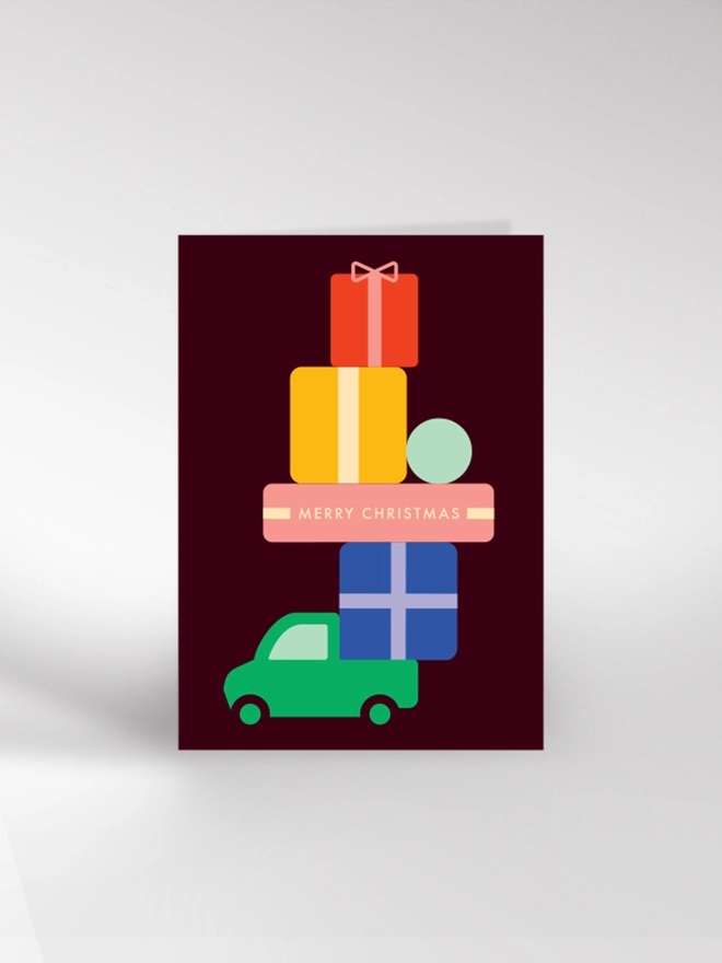 Contemporary illustrated Christmas card with  a truck carrying a large pile of presents