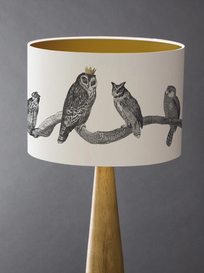 Drum Lampshade featuring owls on a branch with a gold inner on a wooden base 