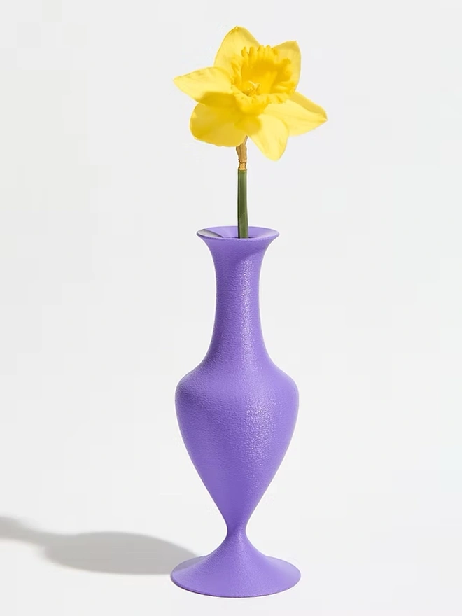 curvy shaped 3d printed vase in purple with yellow flower