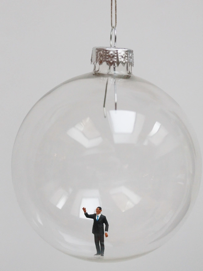 Miniature figure of a Barak Obama in a glass hanging christmas bauble 