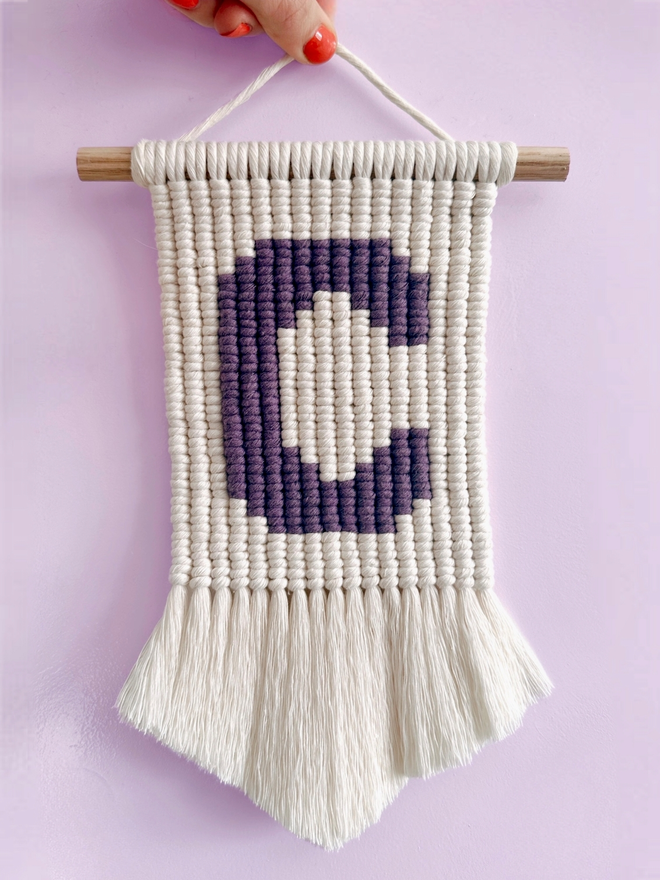 C wall hanging in neutral and purple