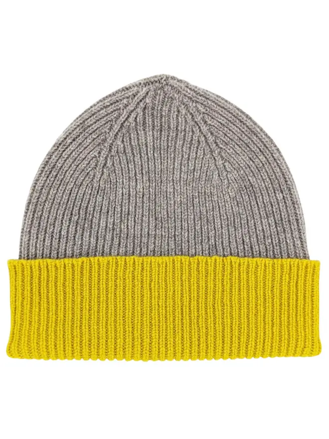 Ribbed Lambswool Women's Beanie, a colourful beanie sitting on a white plain surface. 