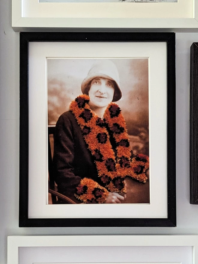 Print of woman wearing embroidered leopard print trim coat framed on wall
