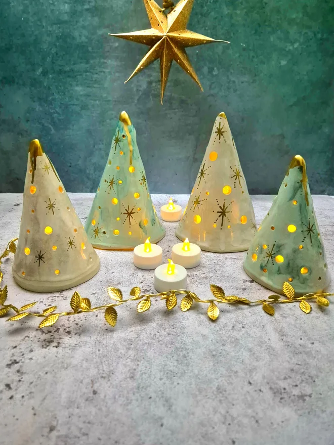 Ceramic christmas tree tea light holder, clay, pottery, Christmas decor, mantlepiece decor, christmas decoration, white with gold details, photographed with a gold star and gold leaves