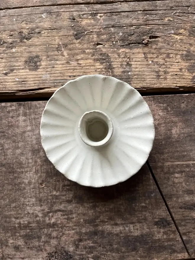 Handmade White Ceramic Candlestick Holder, a white candle holder sitting on a wooden surface. 