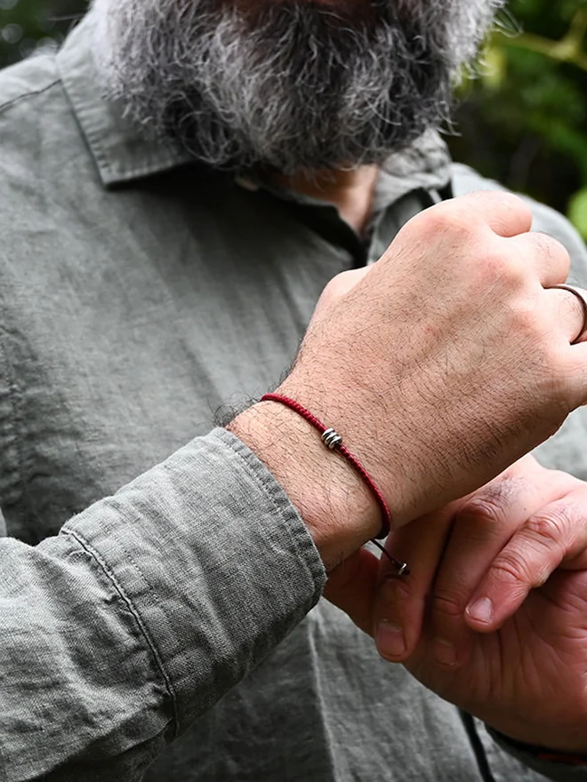 red cord bracelet