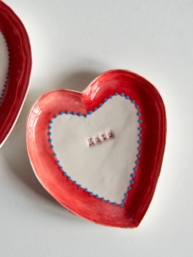 Personalised ceramic heart trinket dish. A personalised heart ceramic dish with a name stamped in red.