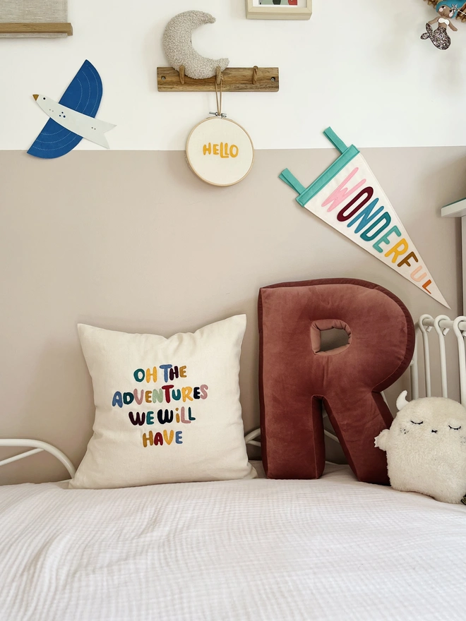 custom cotton cushion cover. embroidered cotton cushion on beige sofa.