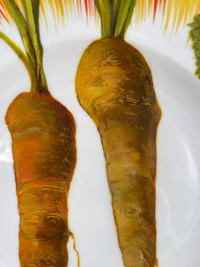 Zoom-in on Oil Painted Two Carrots On A Vintage Cake Plate. 