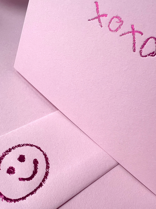 candy pink coloured card with xoxo hand foiled in kids hand writing