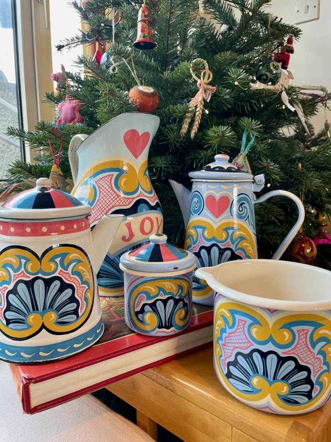 Collection of hand painted enamelware with fairground designs