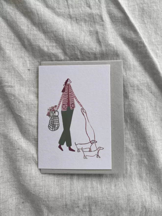 greetings card with a lady walking her dog on it. 