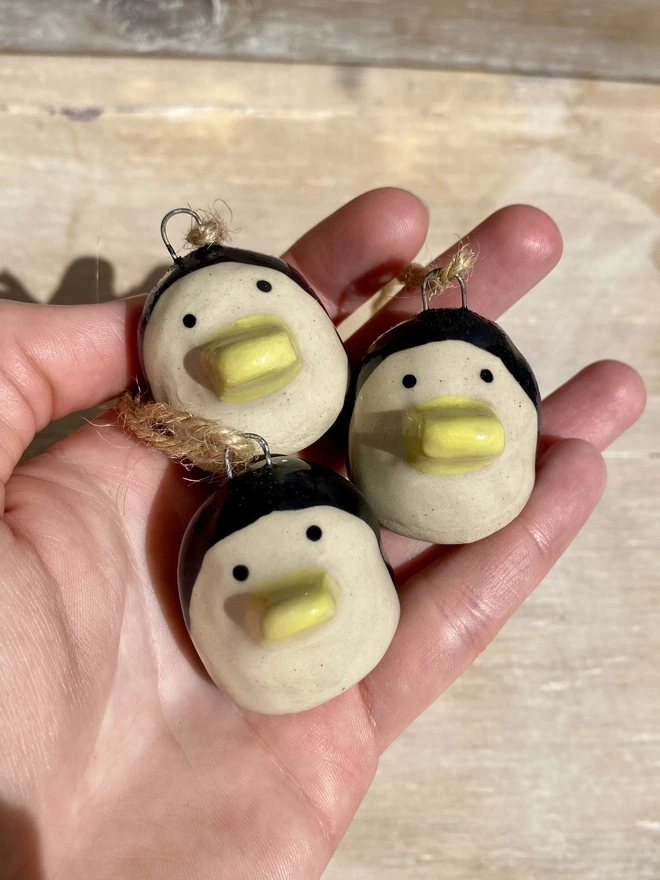 ceramic penguin hanging decoration - held