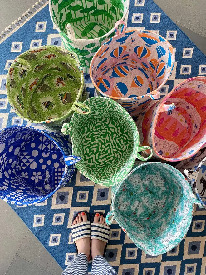 Collection of colourful Quilted Storage Baskets on a blue rug.